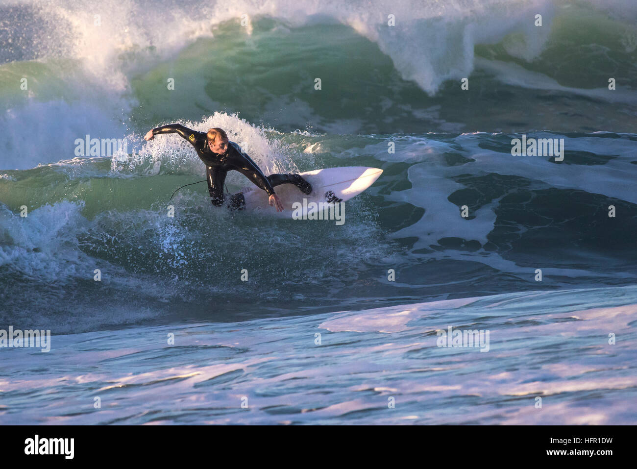 A surfer in spectacular action at Fistral in Newquay, Cornwall, England. UK. Stock Photo