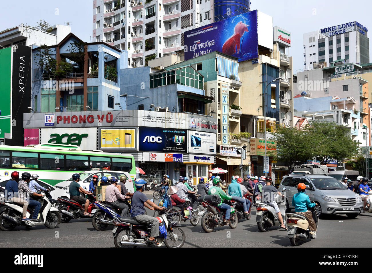 Rush hour commuters car taxis scooters motorcycles Pham Viet Chanh street - Nga Sau Cong Hoa  Ho Chi Minh City (Saigon) Vietnam Stock Photo