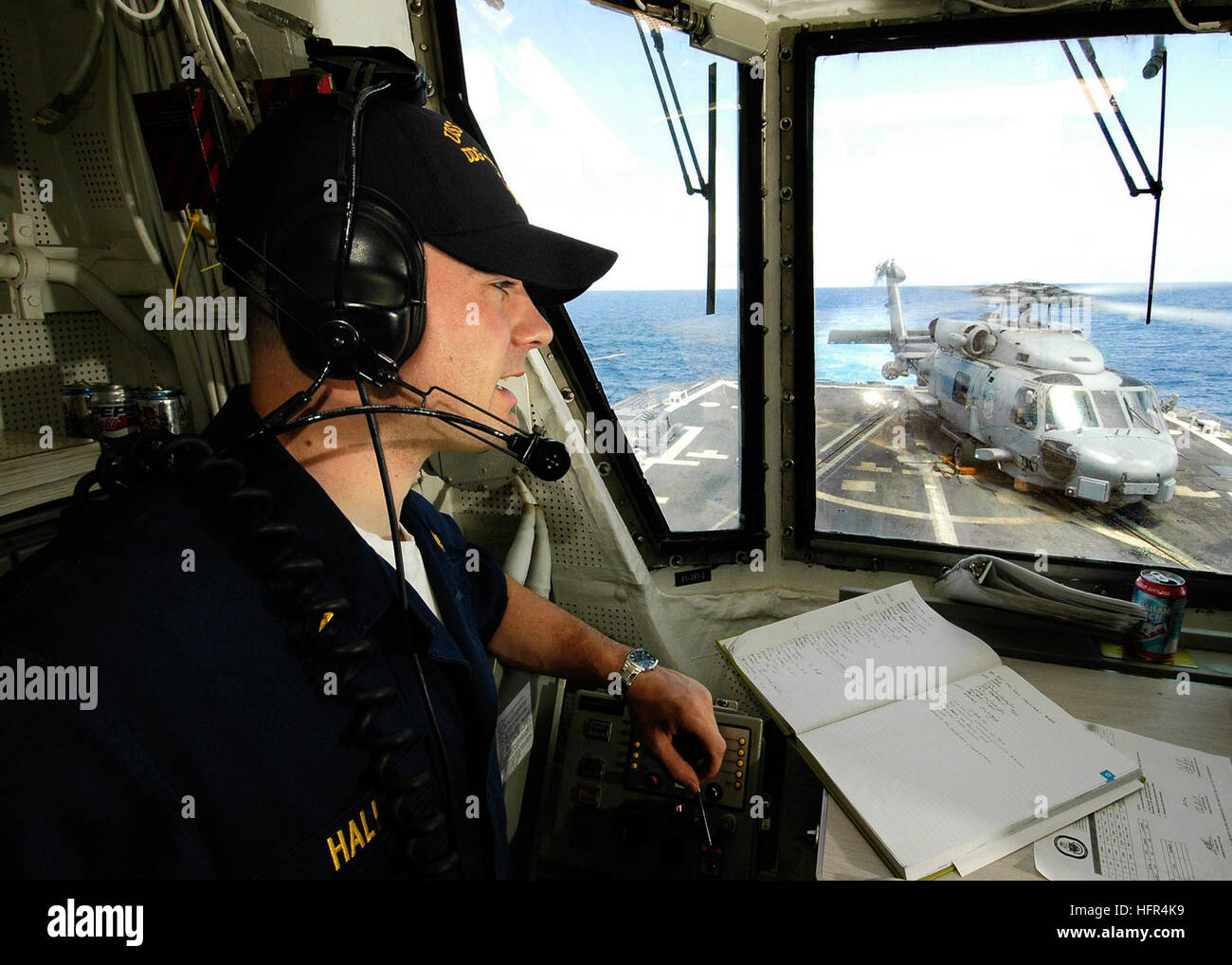 060412-N-7981E-132 Pacific Ocean (April 12, 2006)- Ensign Justin Hall makes status reports to the bridge while standing watch as Helicopter Control Officer during flight operations aboard the Arleigh Burke-class guided missile destroyer USS Shoup (DDG 86). Shoup is currently underway in the Western Pacific area of operations conducting a scheduled deployment. U.S. Navy photo by Photographer's Mate Airman James R. Evans (RELEASED) US Navy 060412-N-7981E-132 Ensign Justin Hall makes status reports to the bridge while standing watch as Helicopter Control Officer Stock Photo