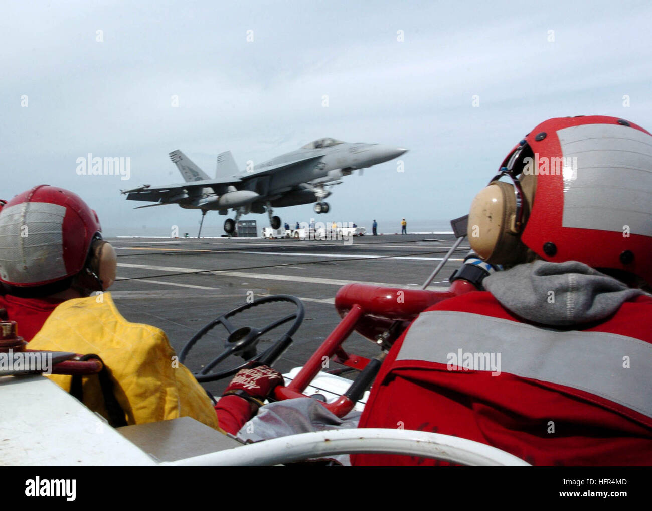 Sailors from the Crash and Salvage team observe an F/A-18 Super Hornet ...