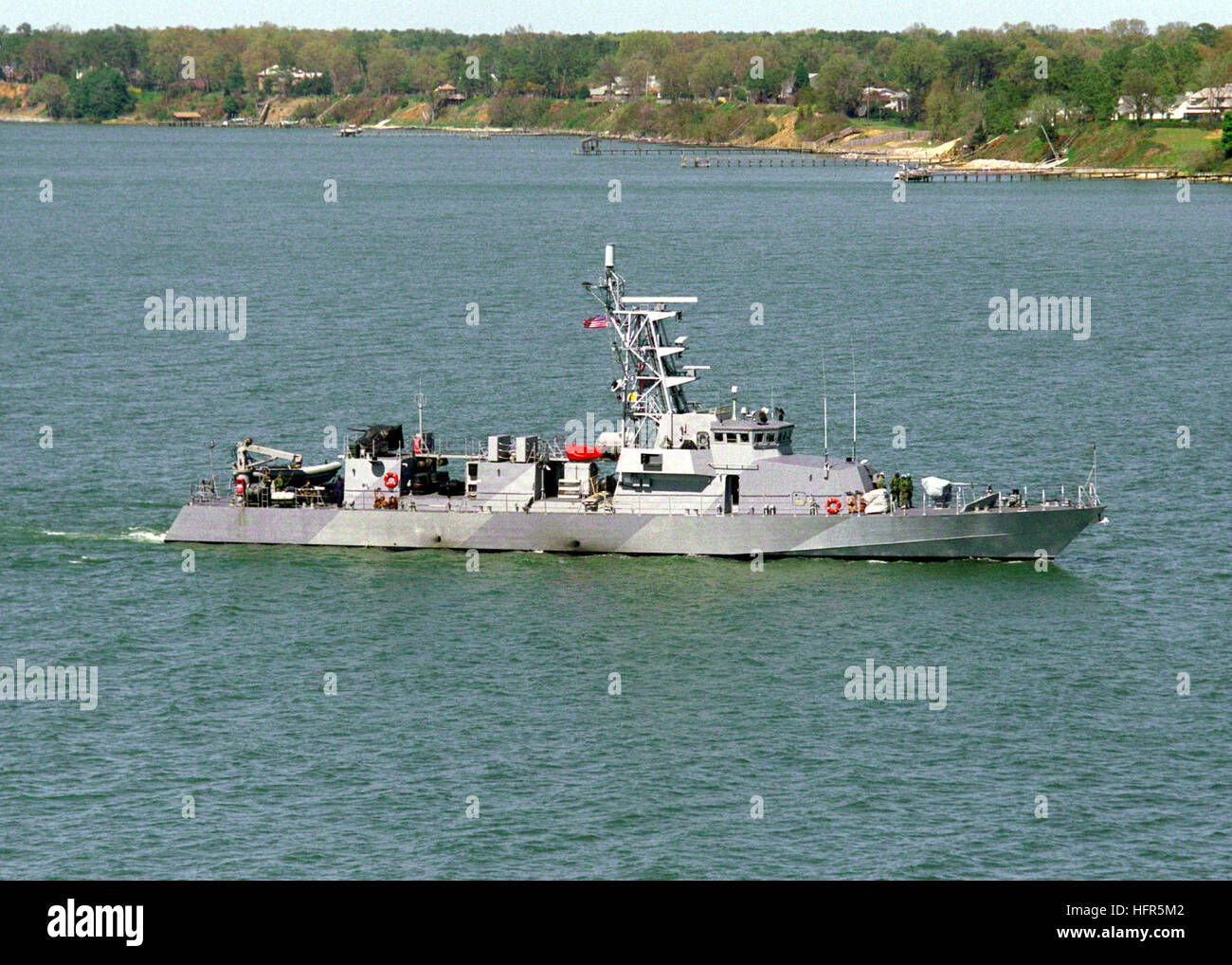 990405-N-0000C-001 Yorktown, VA. (Apr. 5, 1999) -- The U.S. Navy Cyclone Class Patrol Craft USS Firebolt (PC 10) passes by the Naval Weapons Station at Yorktown, VA.  The starboard side view shows the vessels splinter camouflage paint scheme. The patrol craftÕs primary mission is coastal patrol and interdiction surveillance.  These ships also provide full mission support for Navy SEALs and other special operations forces.  U.S. Navy Photo by William H. Clarke. (RELEASED) US Navy 990405-N-0000C-001 USS Firebolt (PC 10) underway Stock Photo