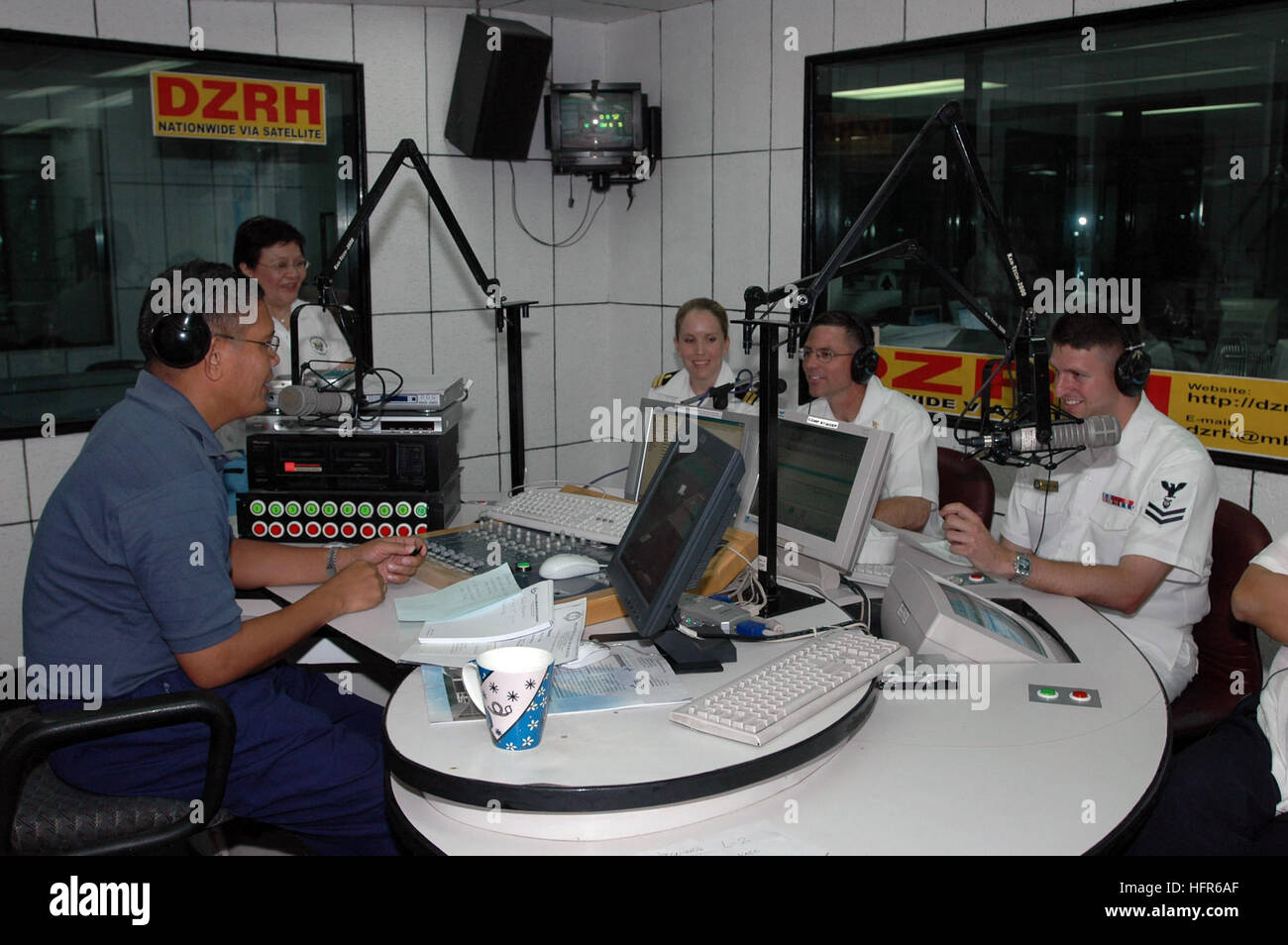 060521-N-9076B-059 Manila, Philippines (May 21, 2006) Ð Seated left to  right, Lt. Janel Rossetto, Chief Musician Donald Chilton and Musician 2nd  Class Ian Charlton appear as guests on the PhilippinesÕ largest radio