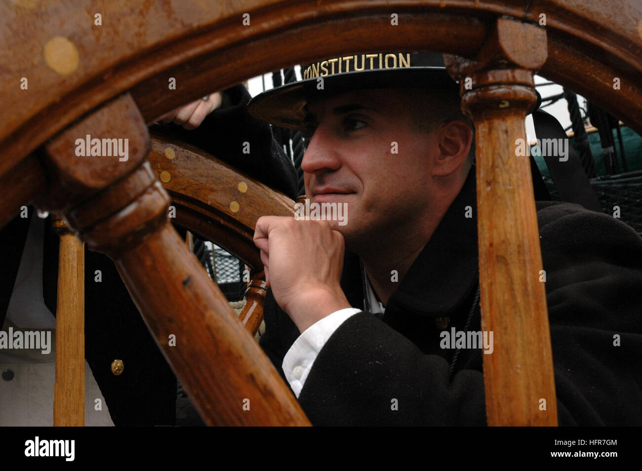 060610-N-5322S-003 Boston (June 10, 2006) - Boatswain Mate 2nd Class Michael Shippee mans the ship's helm aboard 'Old Ironsides' as it is taken out into Boston Harbor for the first time this year during a turnaround cruise in Boston Harbor. The turn-around cruise is one of the high points of Boston Navy Week. Twenty-four such weeks are planned this year in cities throughout the U.S., arranged by the Navy Office of Community Outreach (NAVCO). NAVCO is tasked with enhancing the Navy's brand image in areas with limited exposure to the Navy. U.S. Navy photo by Seaman Michelle Sowers (RELEASED) US  Stock Photo