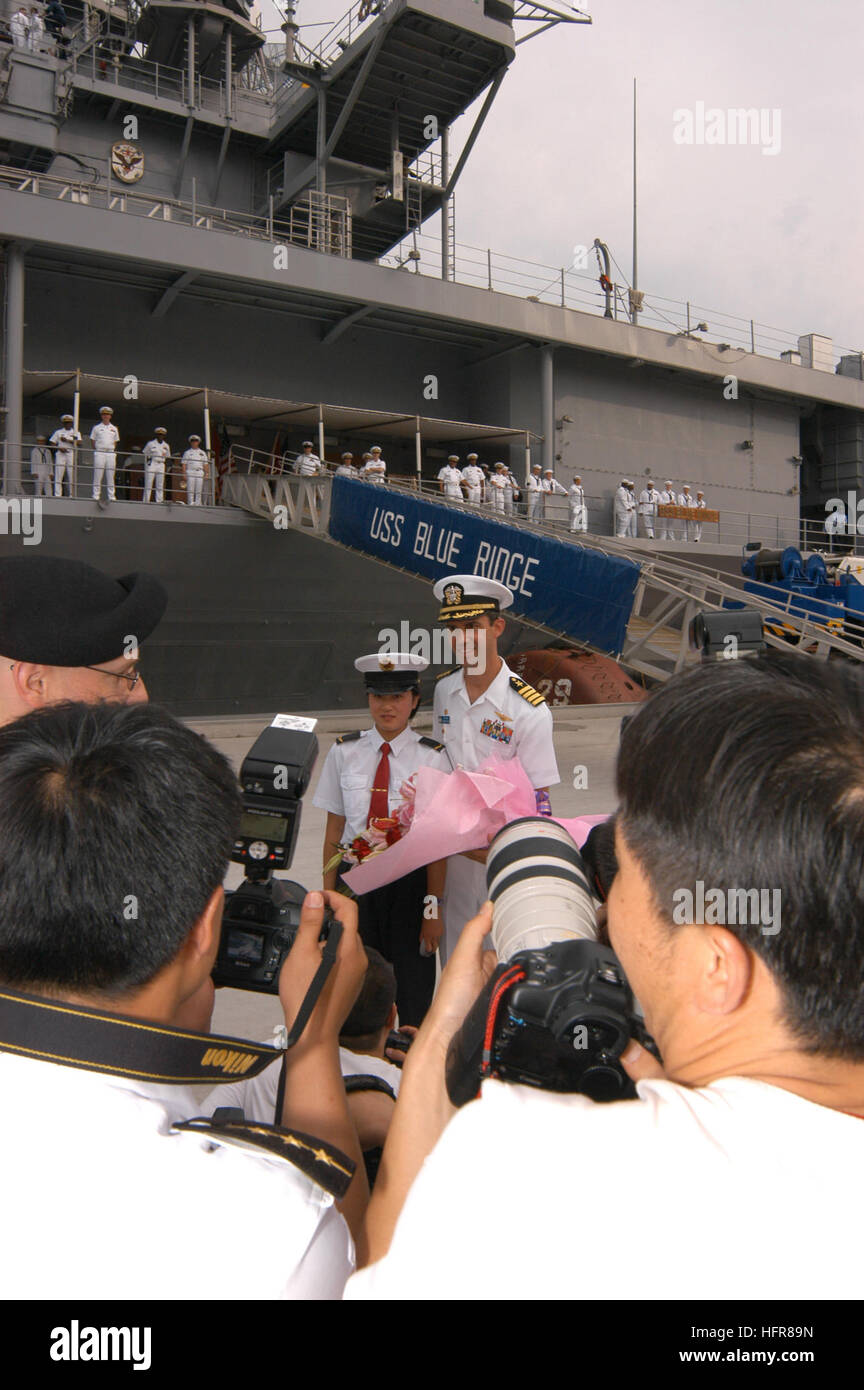 060627-N-5334H-285 Shanghai, China (June 27, 2006) Ð The Commanding Officer for the U.S. NavyÕs Amphibious command ship USS Blue Ridge (LCC 19), Capt. Jeff Bartkoski, receives flowers from a member of the PeopleÕs Liberation Army Navy (PLAN) on Yangtse Pier. While in port the shipÕs 650 Sailors experienced Chinese culture and customs, enjoyed sightseeing and interacted with PLAN sailors through sporting events, receptions and guided tours. Blue Ridge is the forward deployed 7th Fleet command ship homeported in Yokosuka, Japan. U.S. Navy photo by Photographer's Mate 3rd Class David J. Hewitt (R Stock Photo