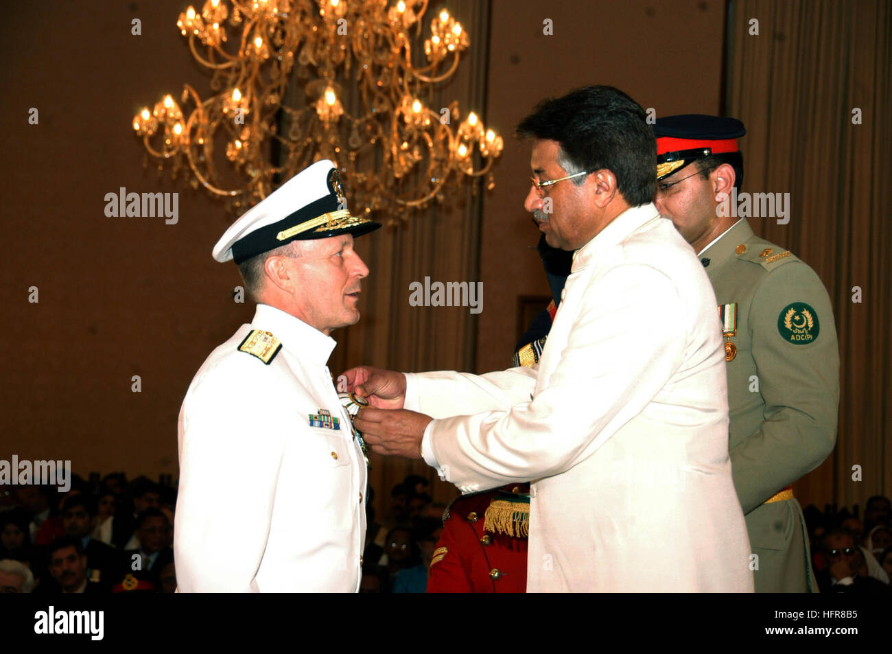 070323-O-0000X-001 ISLAMABAD, Pakistan (March 23, 2007) - Pakistan President Pervez Musharraf presents Rear Adm. Michael A LeFever with the Crescent of Great Leader award, in a ceremony held at the Presidential Palace in Islamabad. LeFever was one of three to receive the high honor, from the President during Pakistan's Military Day, for his efforts while serving as Commander of the Combined Disaster Assistance Center (CDAC) during earthquake relief efforts from the fall 2005 to spring 2006. Photo courtesy of U.S. Embassy in Pakistan (RELEASED) US Navy 070323-O-0000X-001 Pakistan President Perv Stock Photo