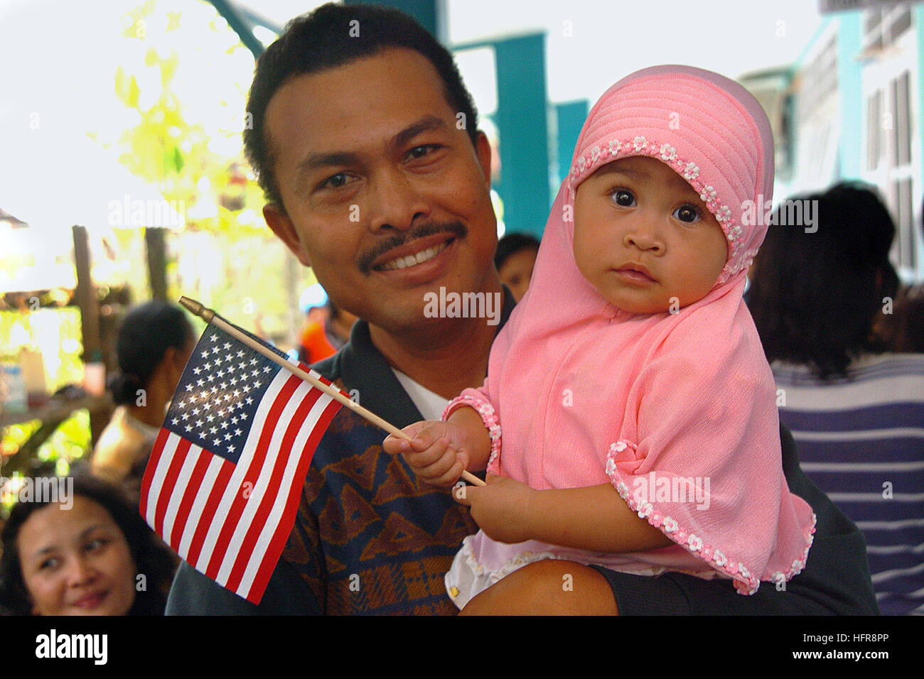 060814-N-6501M-092 Tarakan, Indonesia (Aug. 14, 2006) - An Indonesian father and his daughter wait their turn in the immunizations clinic to be seen by the doctors and staff assigned to the Military Sealift Command (MSC) hospital ship USNS Mercy (T-AH 19) at the Mamburungan outreach site, located on the island of Tarakan. Mercy Continues its one-week stay off the coast of this small Indonesian island located in the province of East Kalimantan while its members provide humanitarian and civic assistance to the people living there. Mercy is in the fourth month of her five-month humanitarian and c Stock Photo