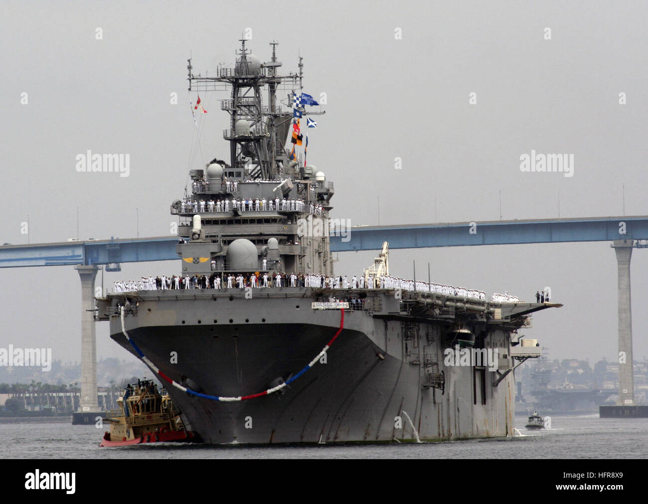 Sailors man the rails aboard USS Peleliu (LHA 5) as the ship returns to ...