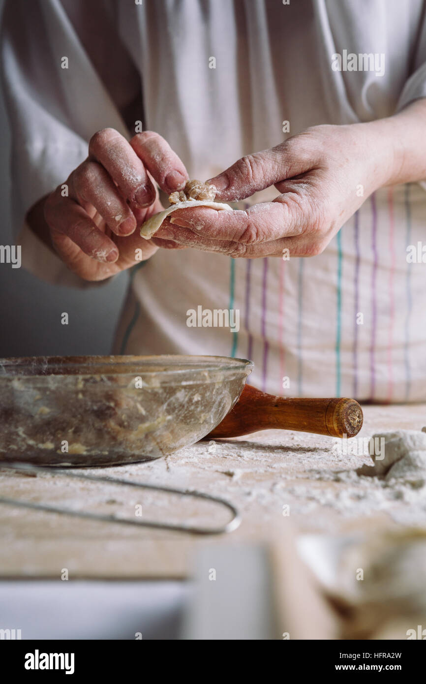 Two hands making meat dumplings. Stock Photo