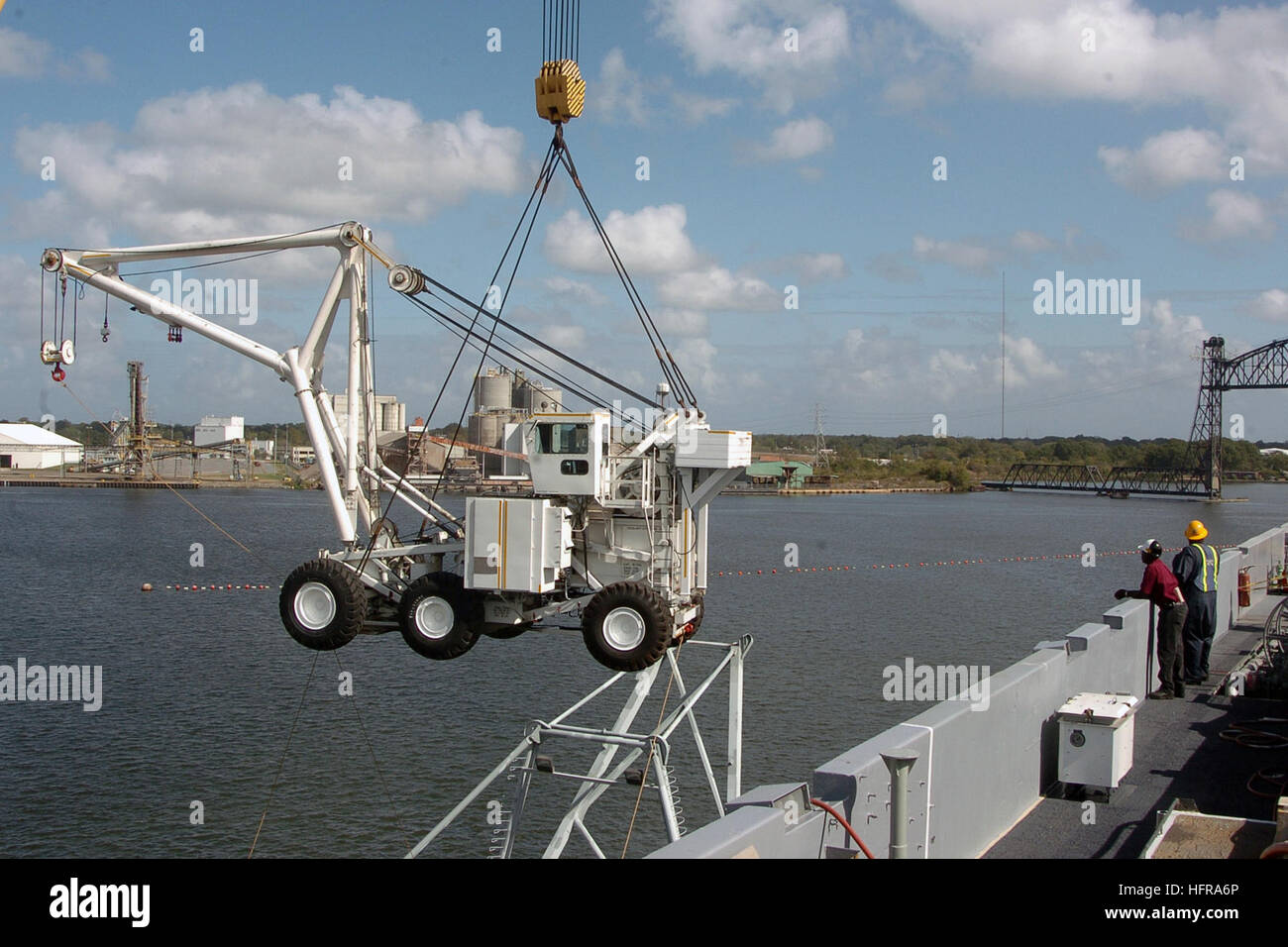 A carrier crash crane is lifted onto the deck of nuclear-powered ...