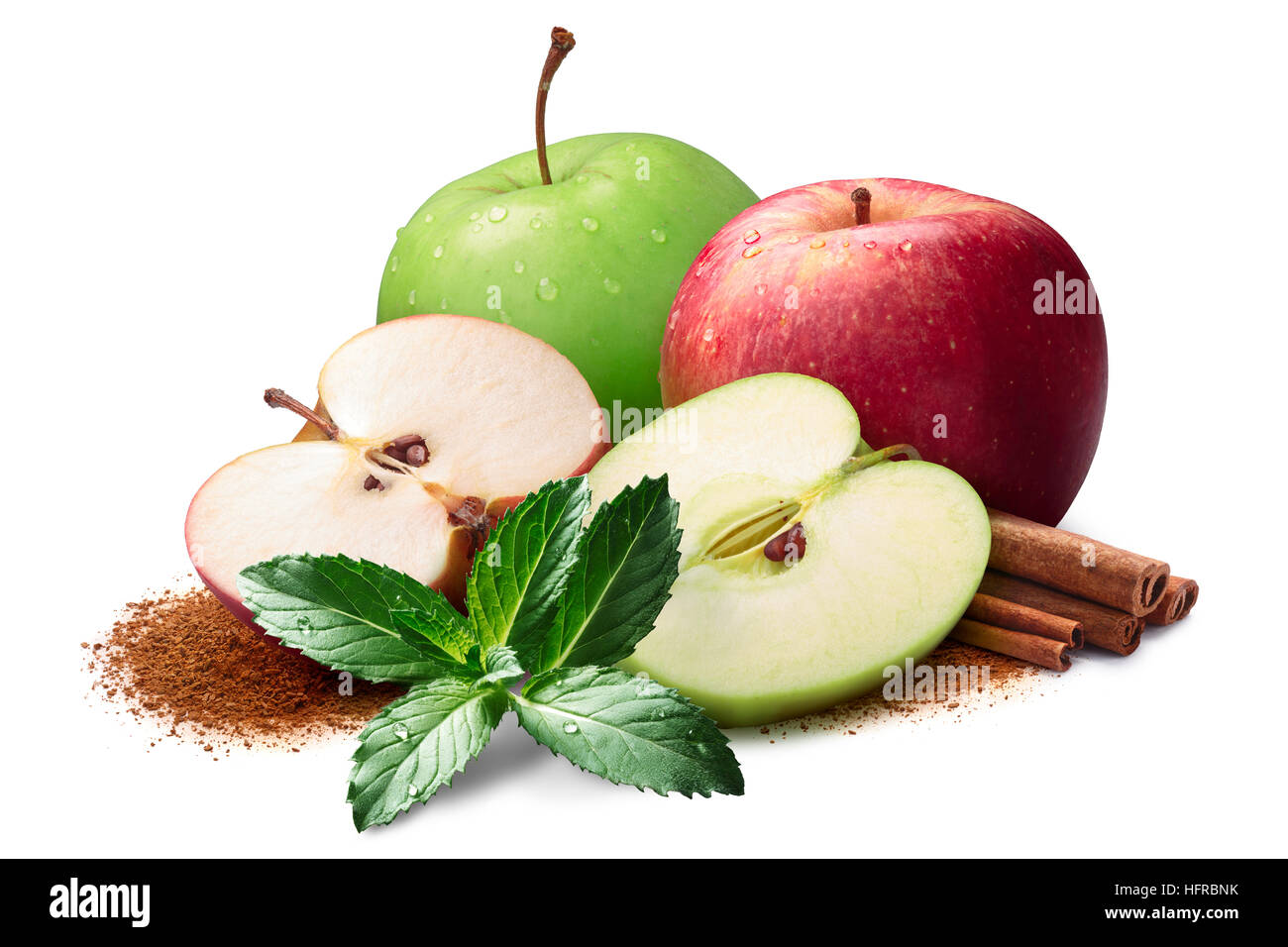 Mint, whole and halved red and green apples next to piles of cinnamon, in sticks and ground. Clipping paths, shadow separated Stock Photo