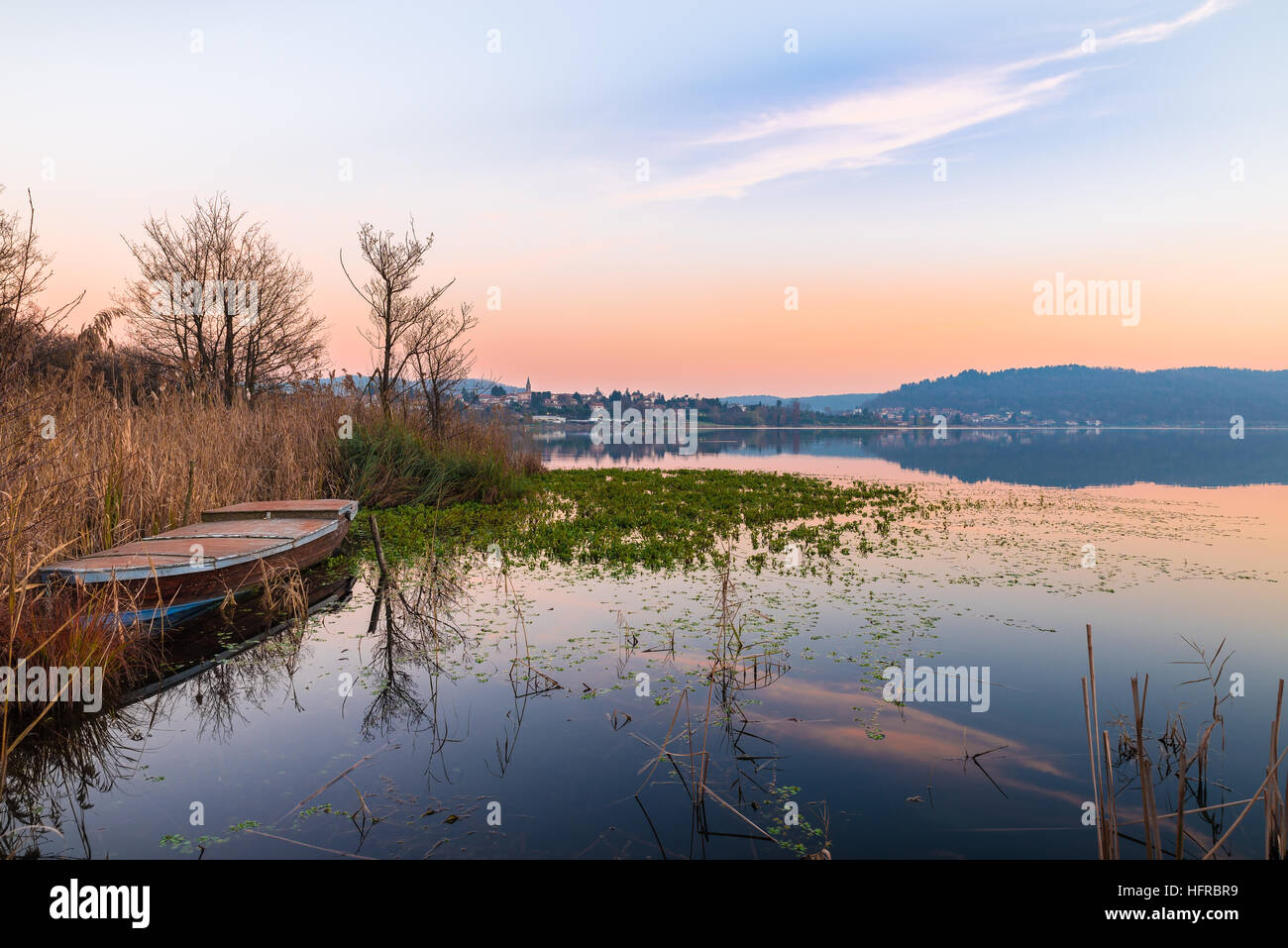 Lake Comabbio in autumn at sunset. On the background Varano Borghi; province of Varese, Italy Stock Photo