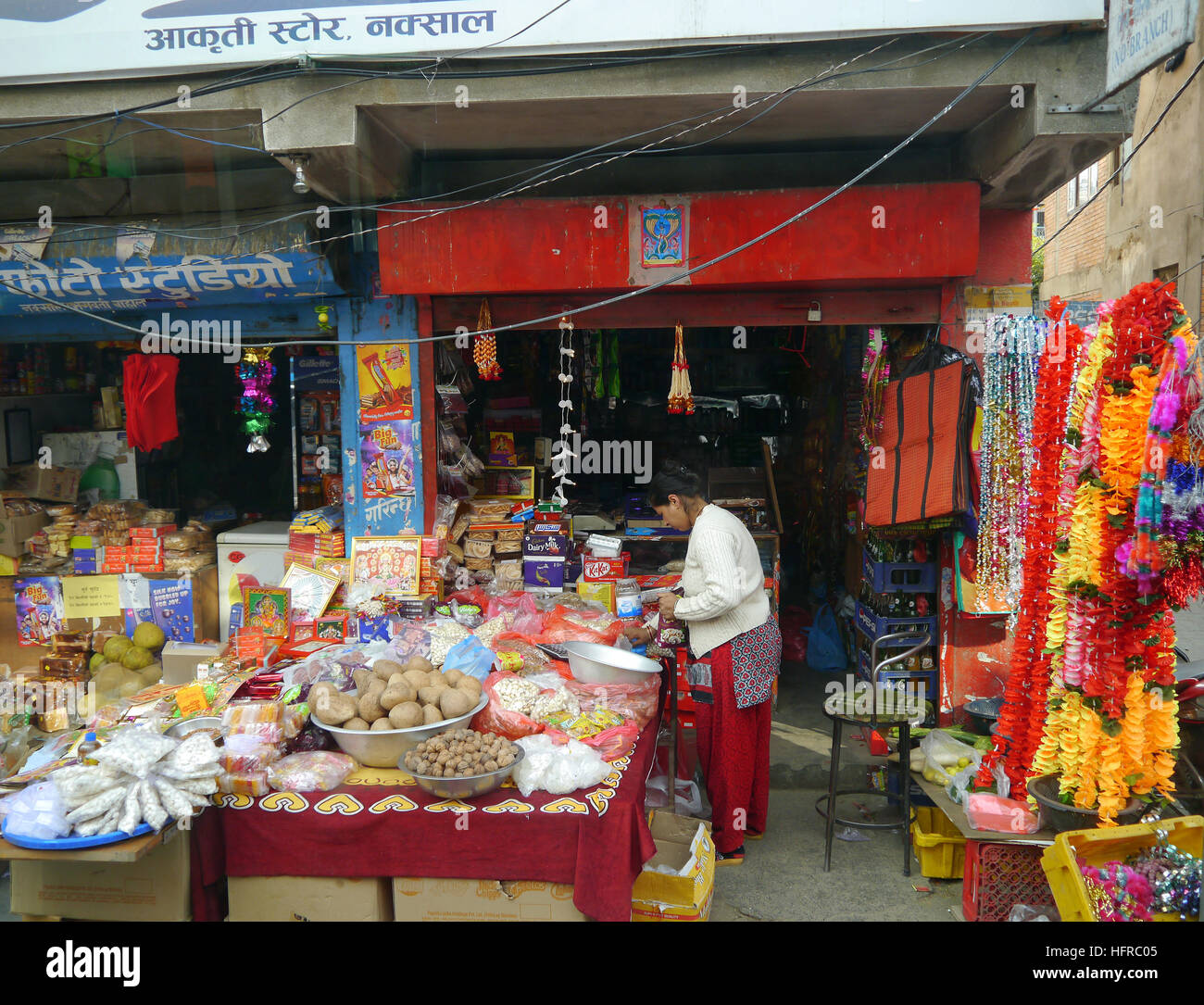 A Nepalese Woman Shopkeeper Selling Goods from a Her Shop for the Festival of Light (Deepawali) in Kathmandu, Nepal.Asia. Stock Photo