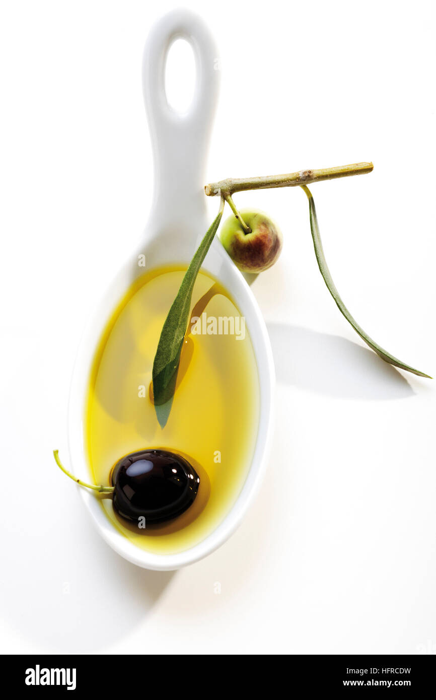 Spoonful of olive oil and olives Stock Photo - Alamy