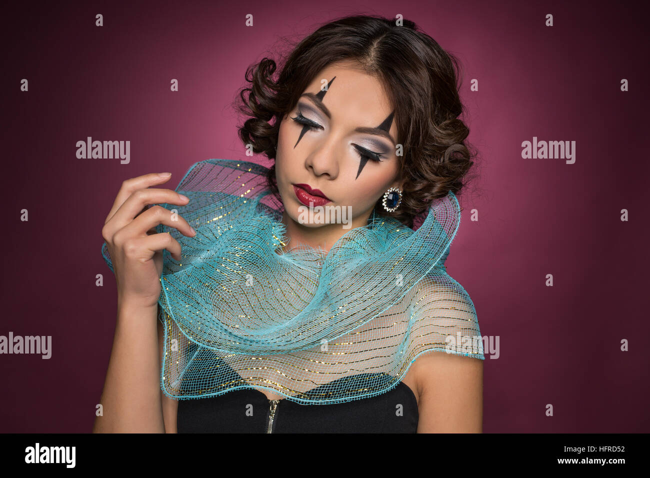 Portrait of young woman, harlequin makeup Stock Photo