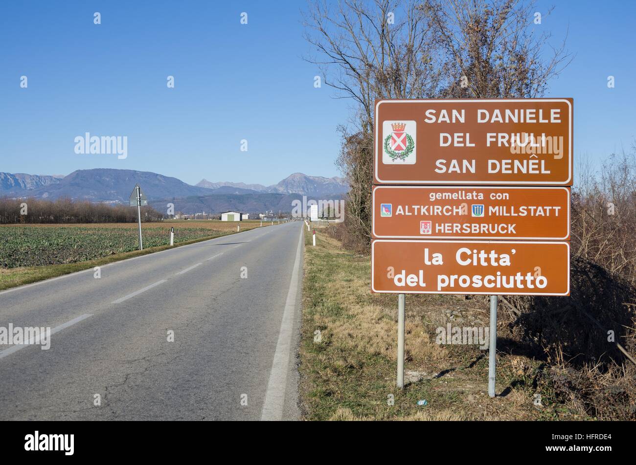 Road sign of San Daniele del Friuli, 'the town of the ham' ('La città del prosciutto') Stock Photo