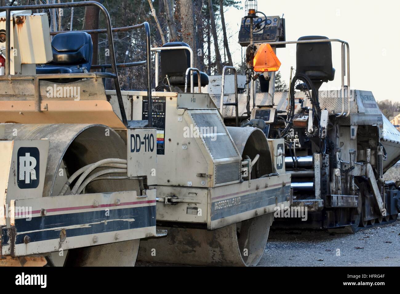 Road paving construction equipment parked in a construction zone Stock Photo