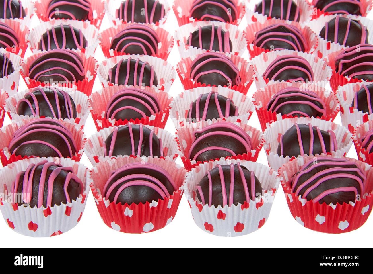 Chocolate cake balls stripped with pink candy melts for Valentines Day  treats. Presented in miniature cupcake liners pink white and red polka dots  on Stock Photo - Alamy