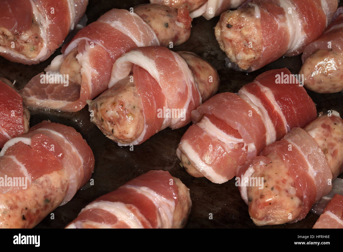Sausages with bacon. Christmas fare in the kitchen. Stock Photo