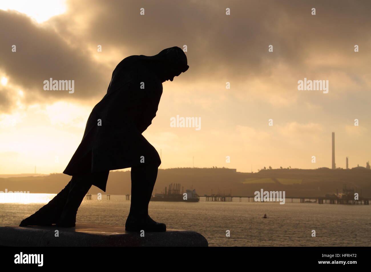Statue at sunrise paying tribute to fishermen at Milford Haven in Pembrokeshire,  Wales.  United Kindom Stock Photo