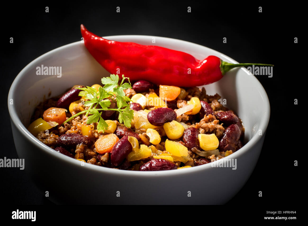 Chili con Carne on black, top view Stock Photo