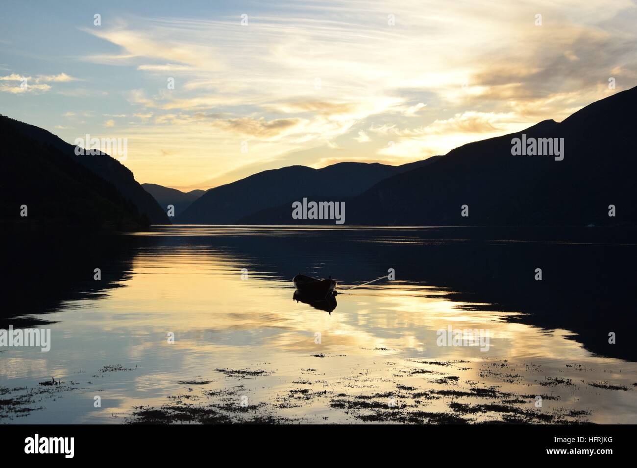 A sunset on a fishing boat in a Fjord in Norway. Stock Photo