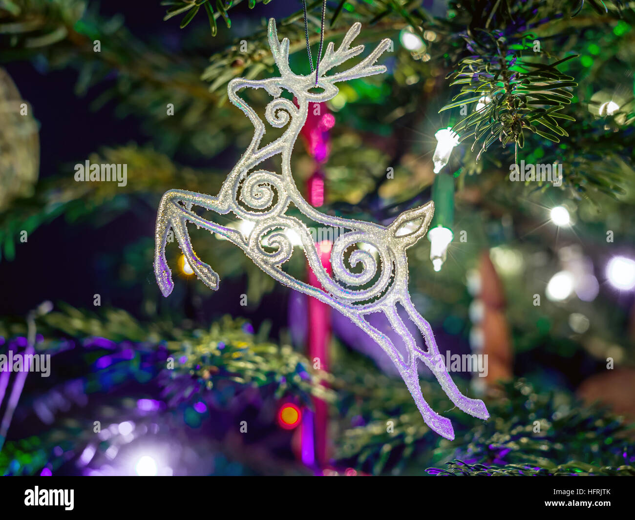 White Christmas reindeer hanging on christmas tree Stock Photo