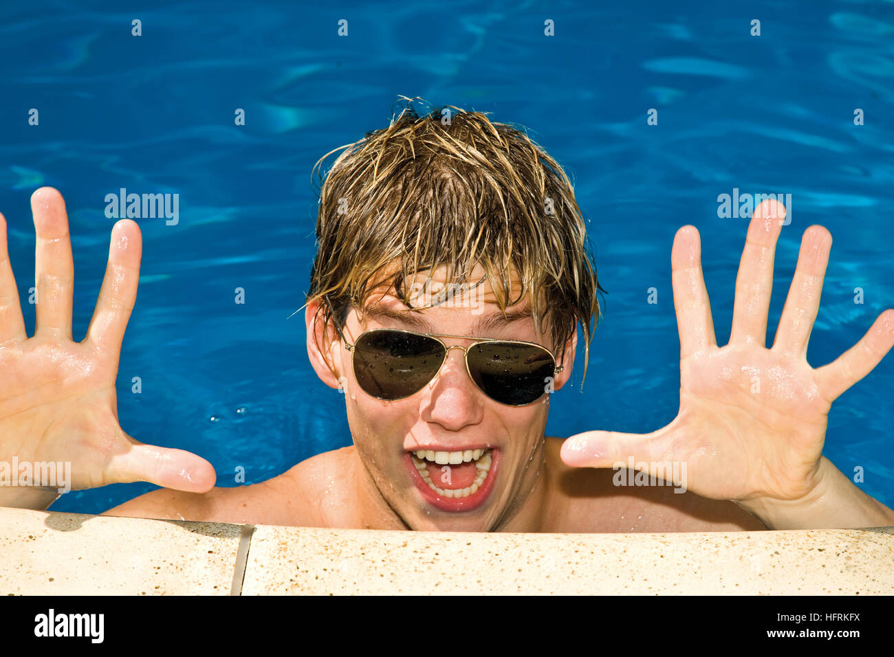Cool guy wearing sunglasses in a swimming pool Stock Photo Alamy