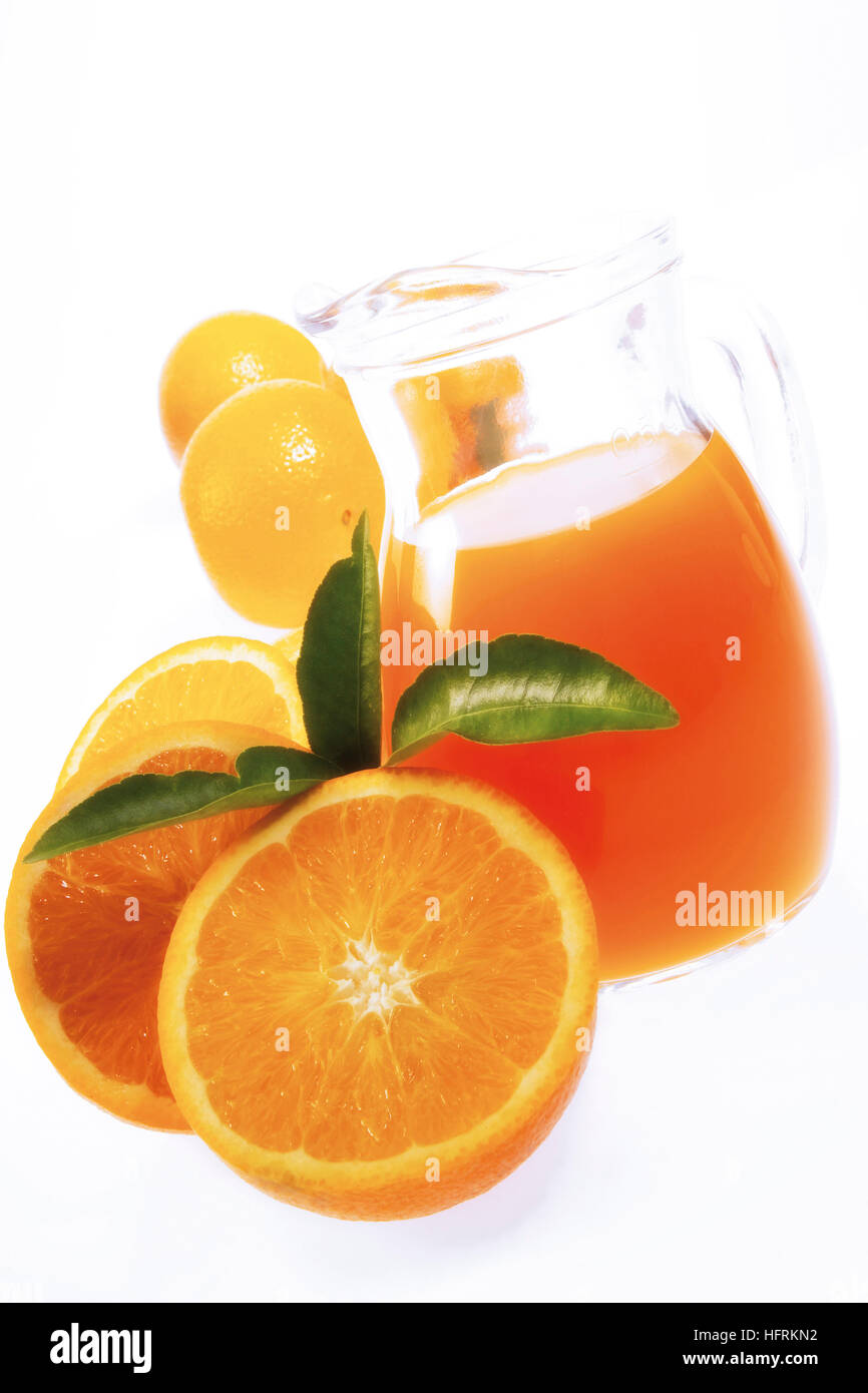 Jug of orange juice, fresh oranges Stock Photo