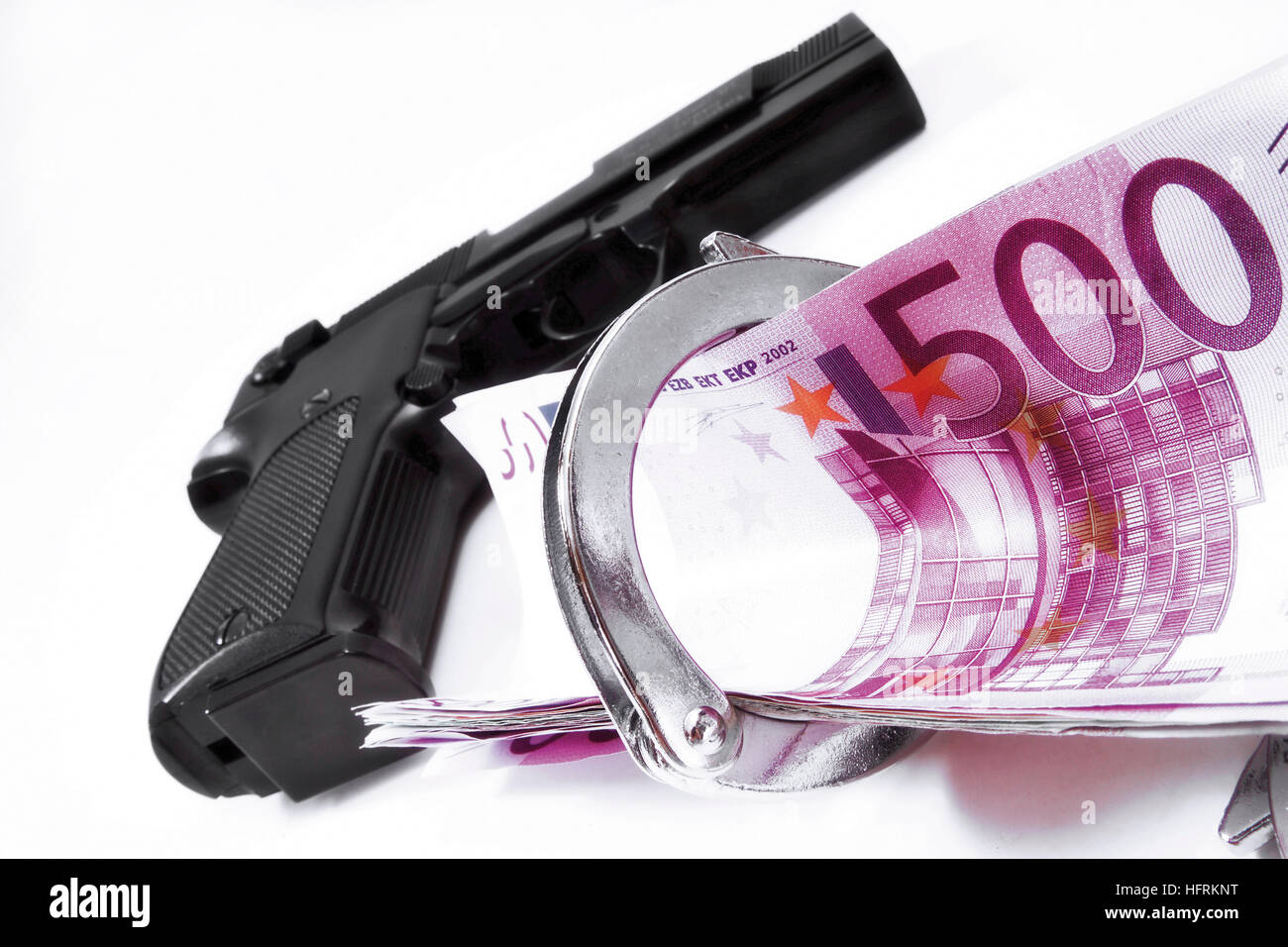 Handgun, handcuffs and cash Stock Photo