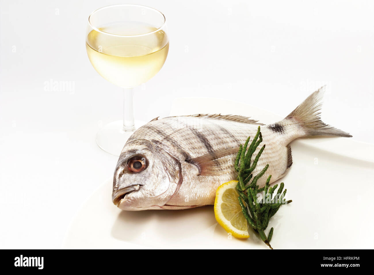 Bass and glass of white wine Stock Photo Alamy