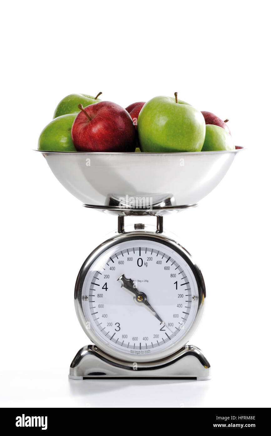 Apples on a kitchen scale Stock Photo - Alamy