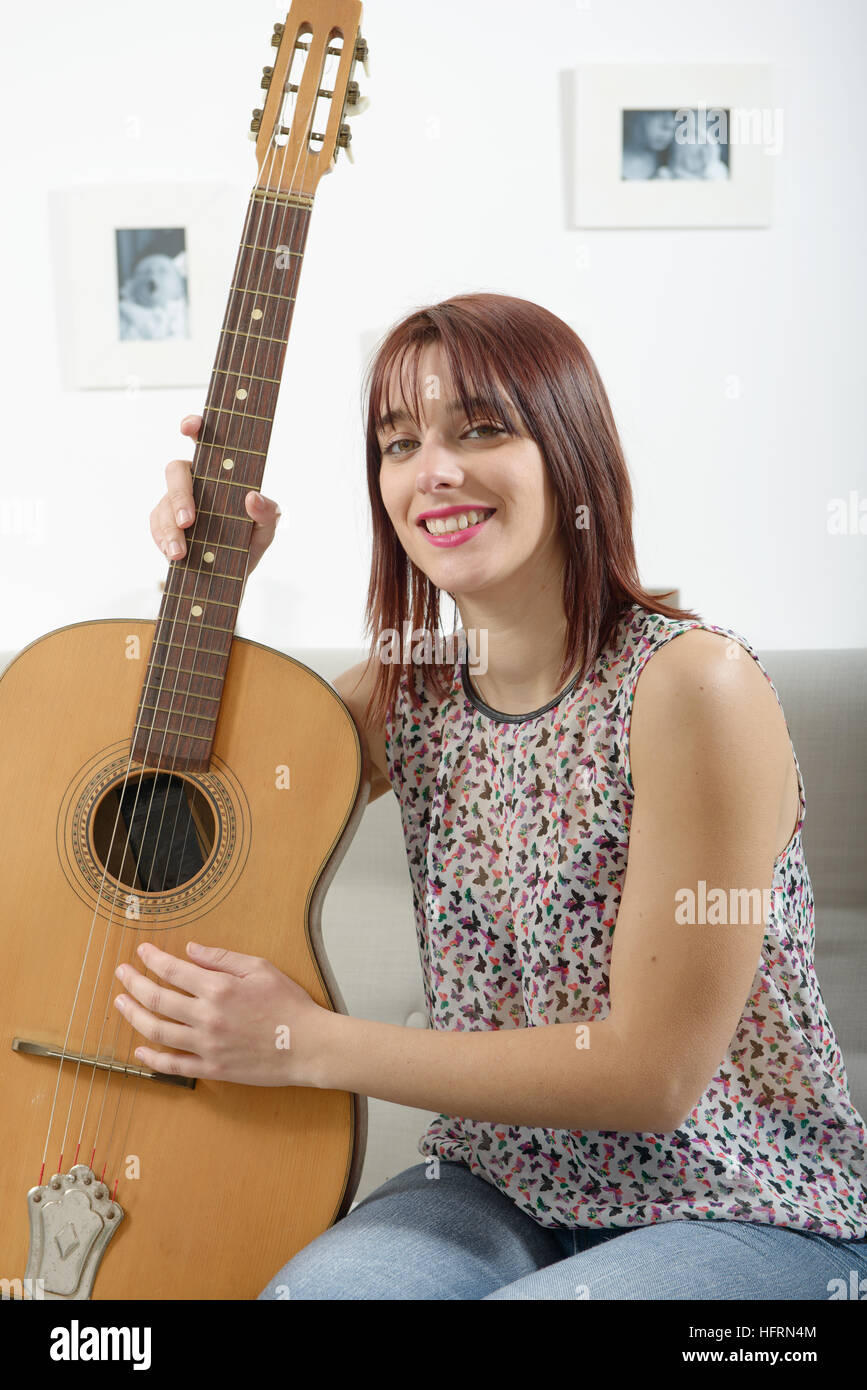 beautiful young woman playing the acoustic guitar at home Stock Photo ...