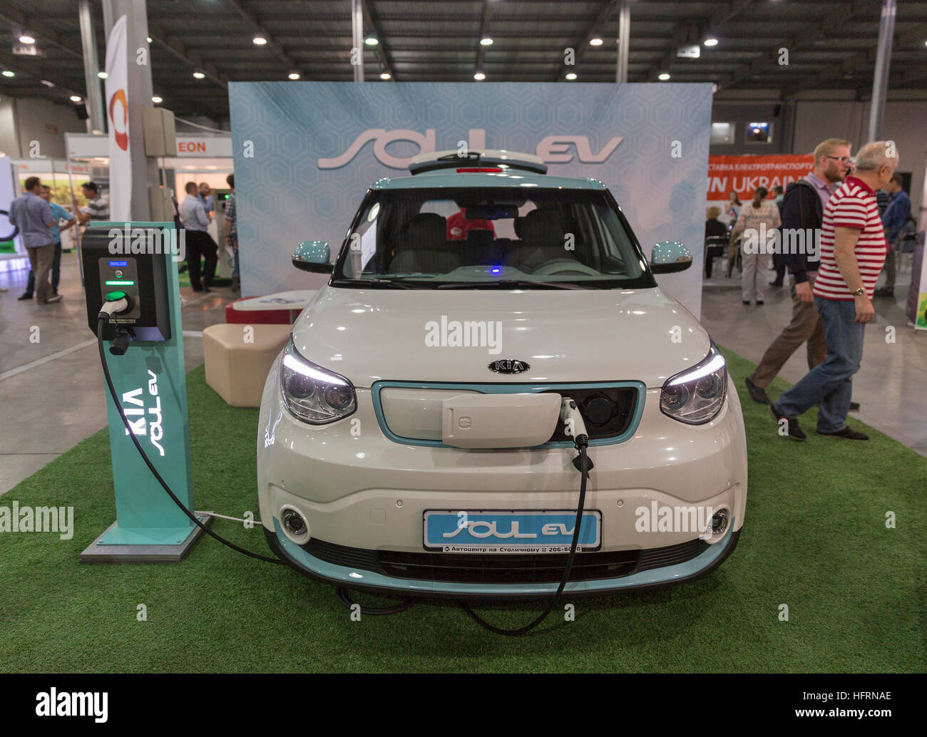 Unrecognized visitors visit Kia Soul EV electric vehicle booth at First