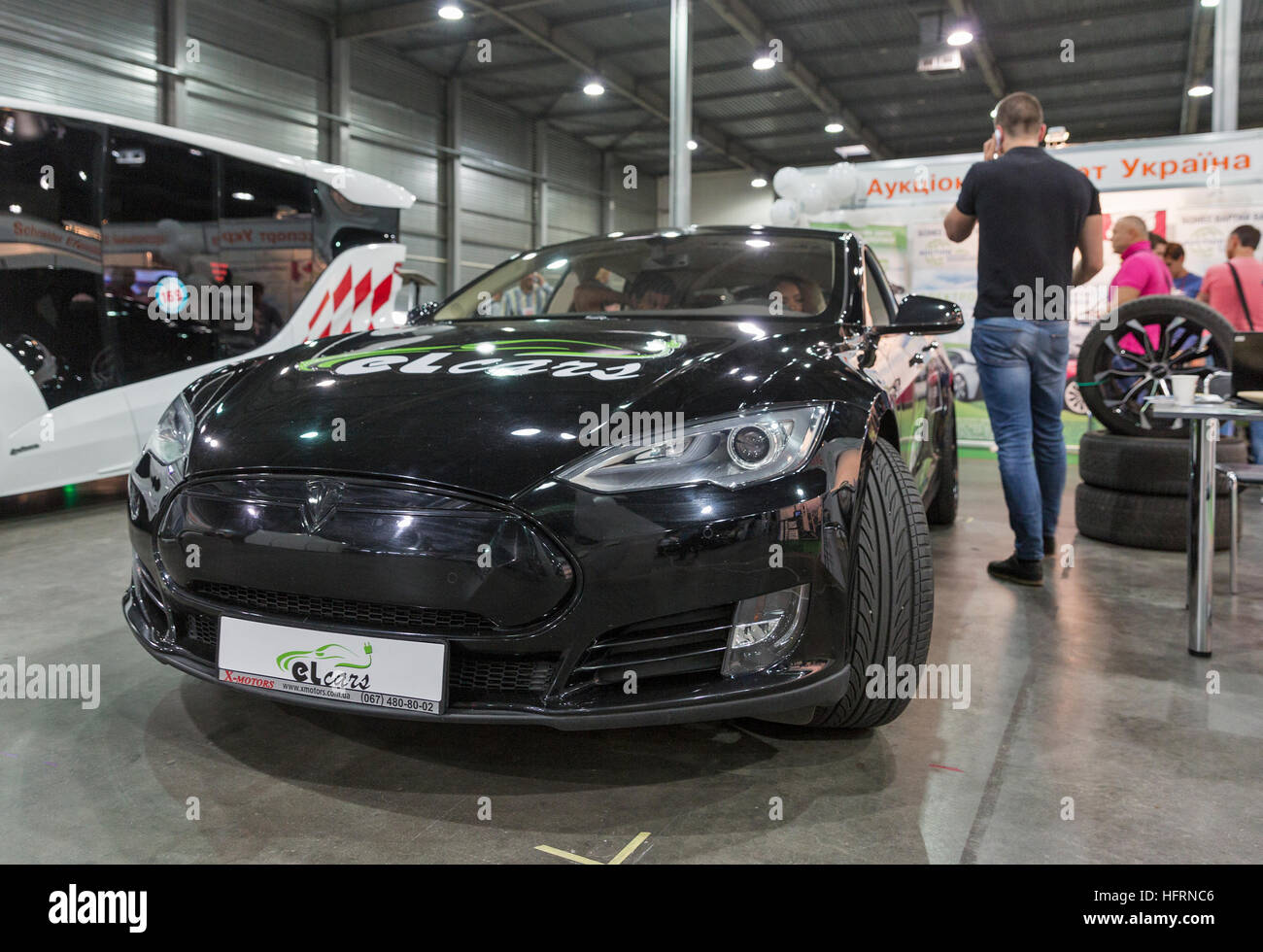 Visitors visit XMotors company booth with Tesla electric car at 1st