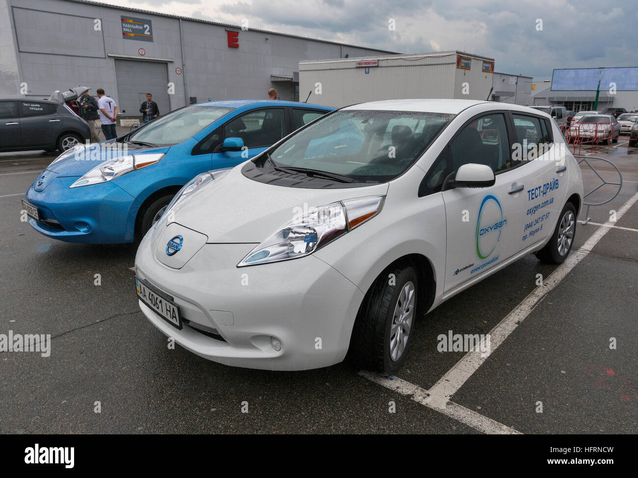 Visitors visit Oxygen Nissan Leaf electric hybrid cars parked ... Visitors visit Oxygen Nissan Leaf electric hybrid cars parked ...