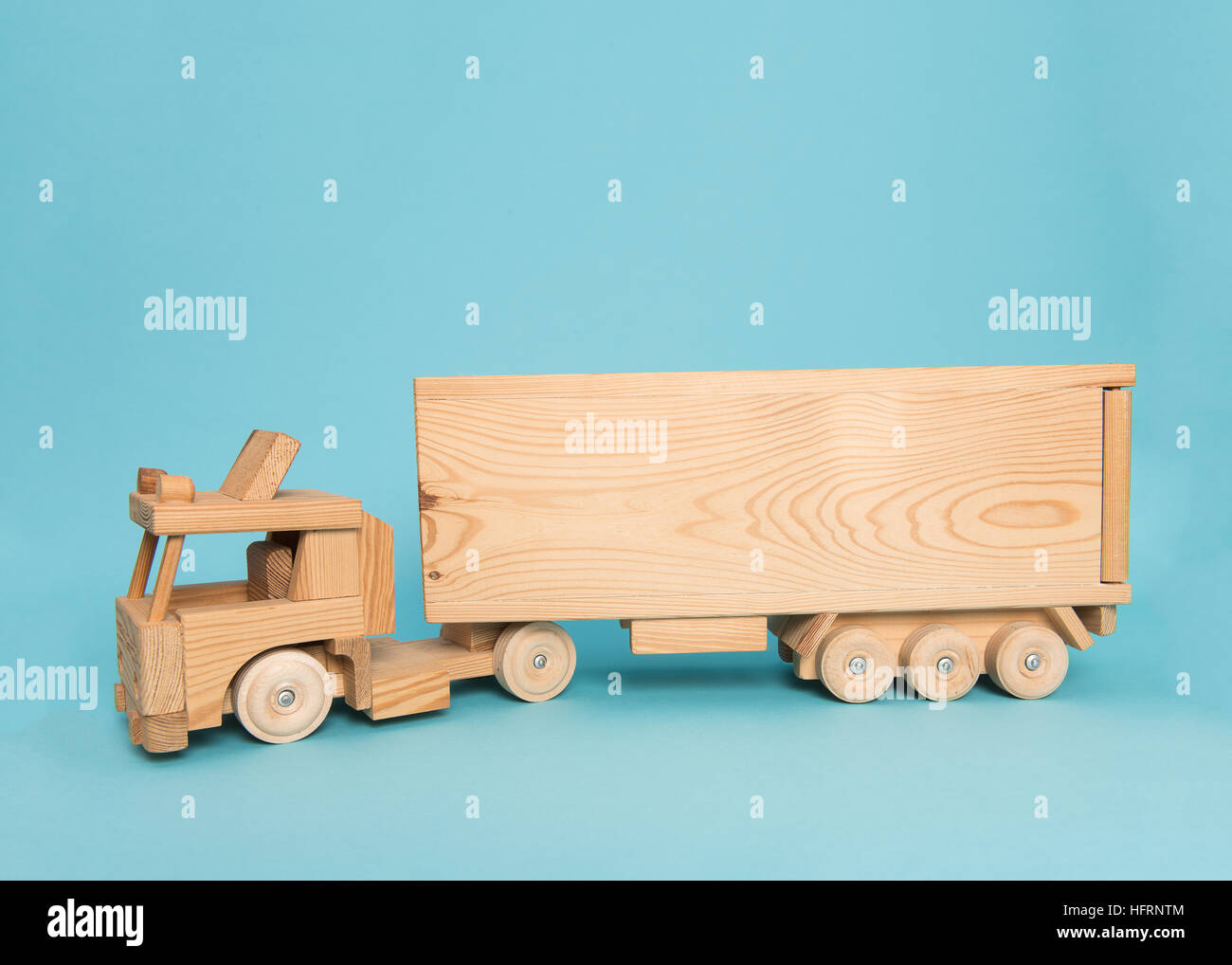 Wooden toy truck on a blue background Stock Photo