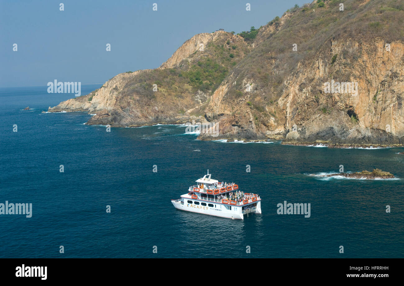 Tourist boat in the Pacific Ocean near Playa Angosta (Angosta Beach) in Acapulco, Mexico Stock Photo