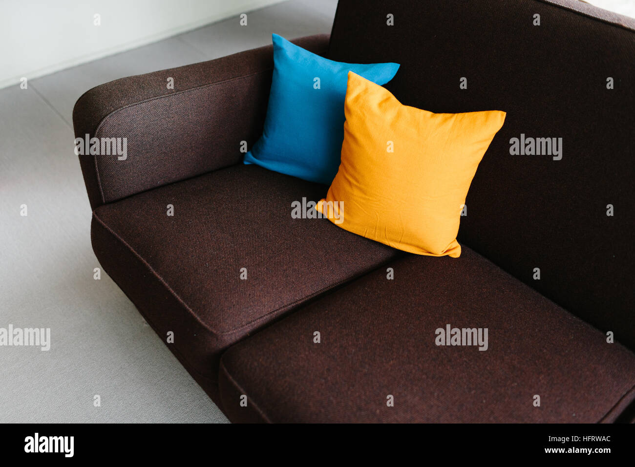 Blue And Yellow Cushions On The Brown Sofa At Rose Seidler House