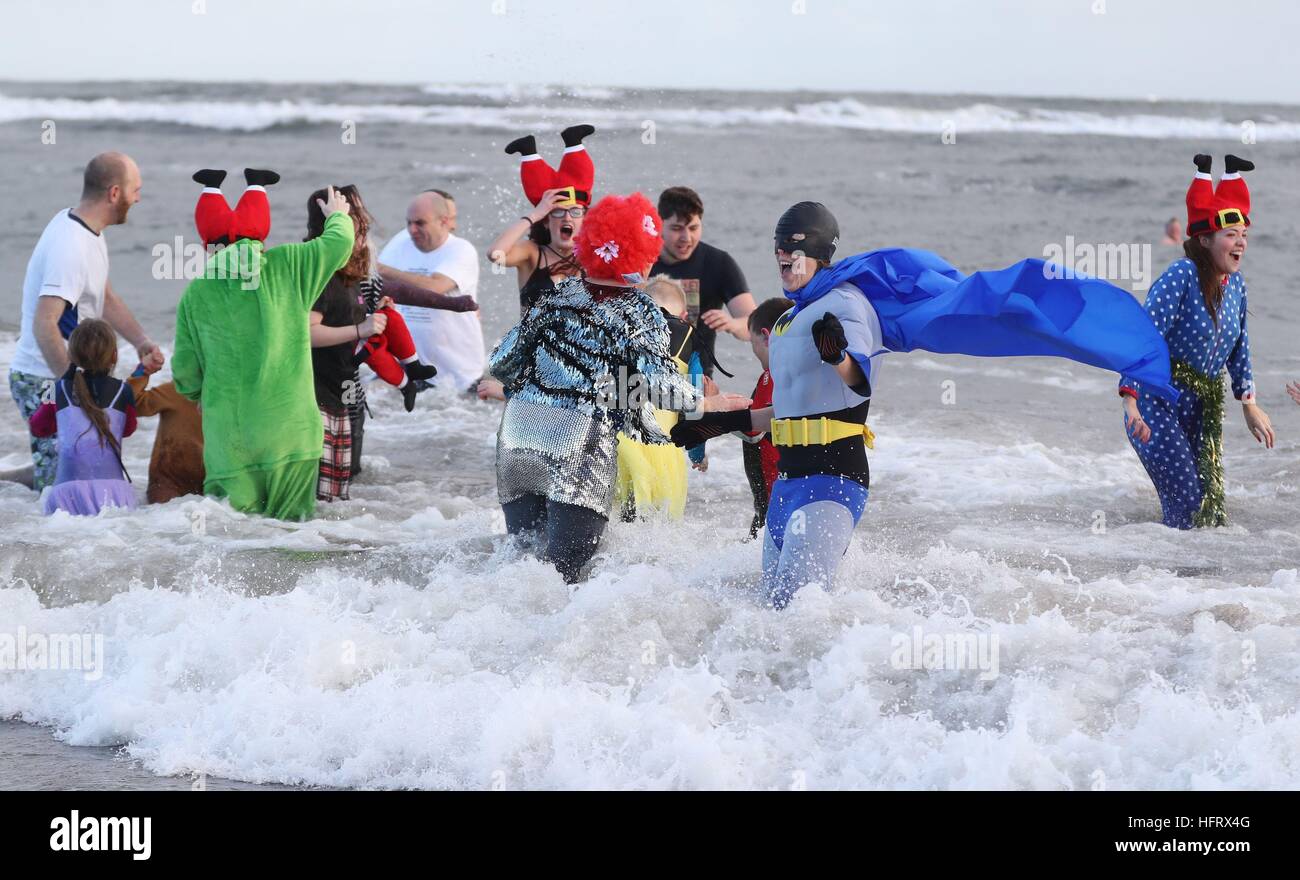 Swimmers take part in a New Year's Day dip in the North Sea at Whitley ...