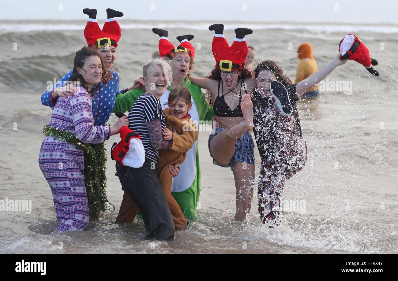 Swimmers take part in a New Year's Day dip in the North Sea at Whitley ...