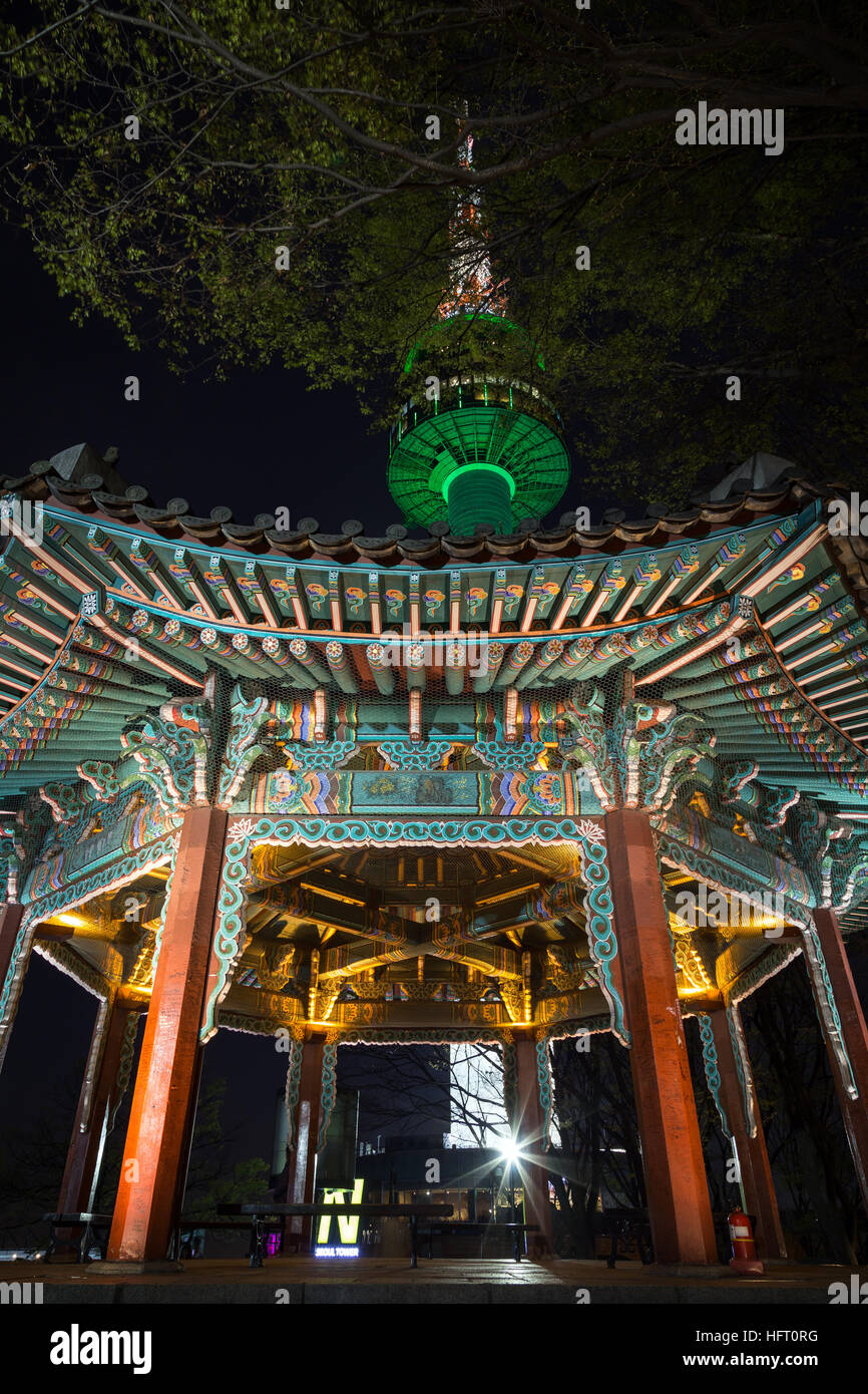 Lit, old & empty pavilion and N Seoul Tower at Namsan Hill (or Namsan Park or Namsan Mountain) in Seoul, South Korea, at night. Stock Photo