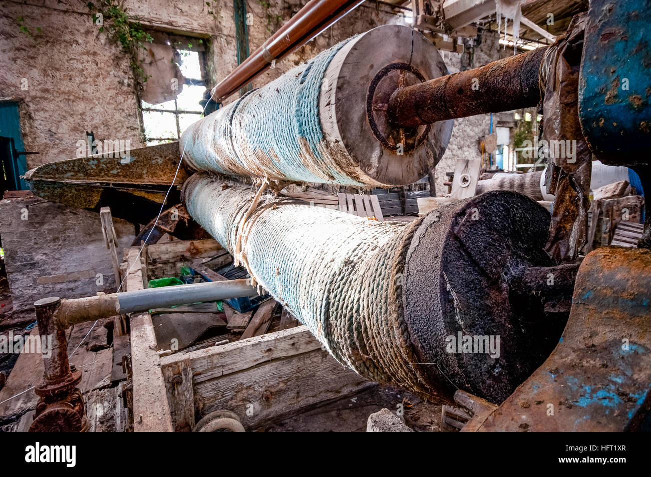 Rope covered rollers beside a loom in a textile weavers. Stock Photo