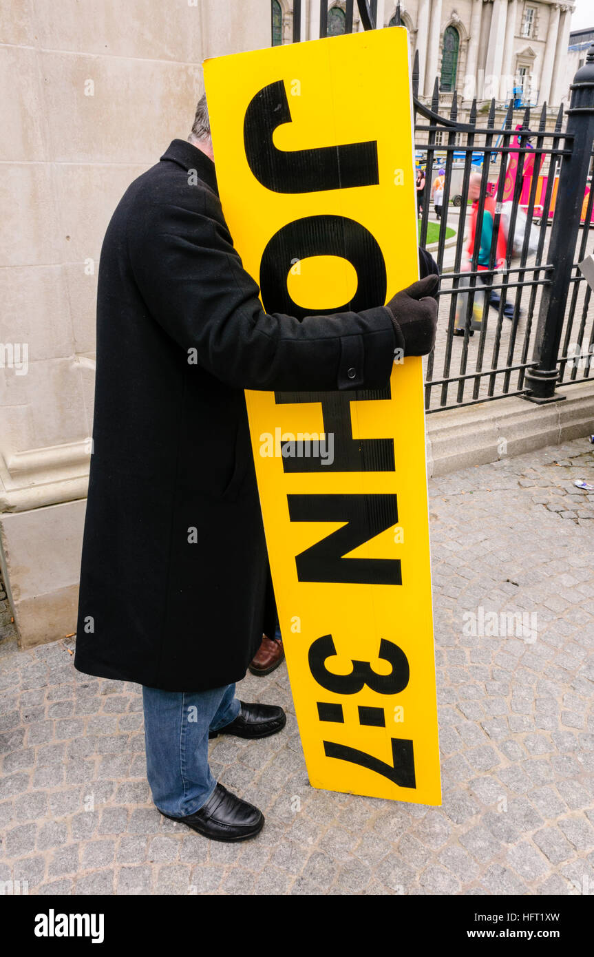 Frank Hogan holds a large sign saying 'John 3:7'.  He famously displays it at events across Ireland. Stock Photo