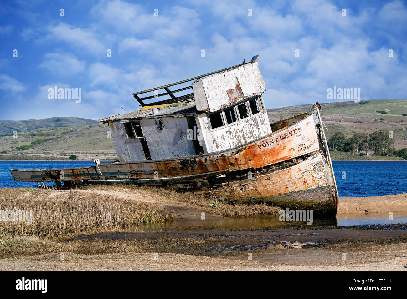 Lateral, panoramic view of an abandoned ship at Inverness, Point Reyes National Seashore, Marin County, California, USA, on a cloudy, sunny day.   I h Stock Photo