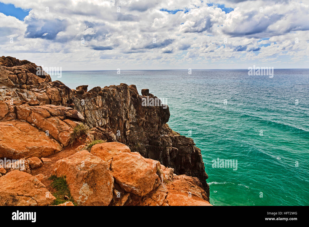 Red bald rocky cliff of Indian Head on Fraser Island national park in Queensland, Australia. Elevated view from rock lookout towards pacific ocean hor Stock Photo