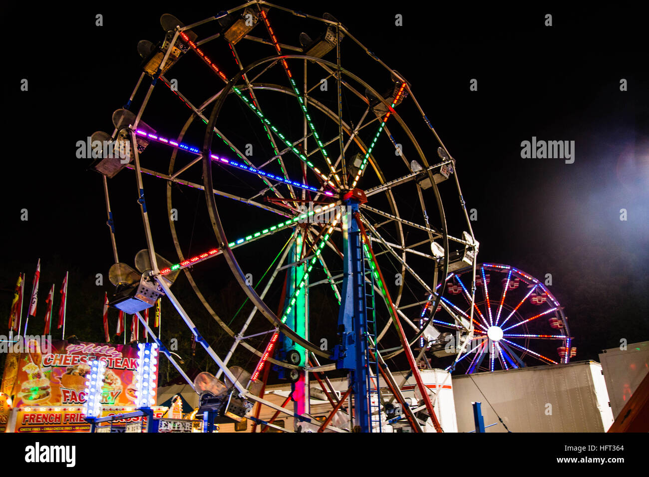 A ferris wheel in an amusement park at night Stock Photo - Alamy