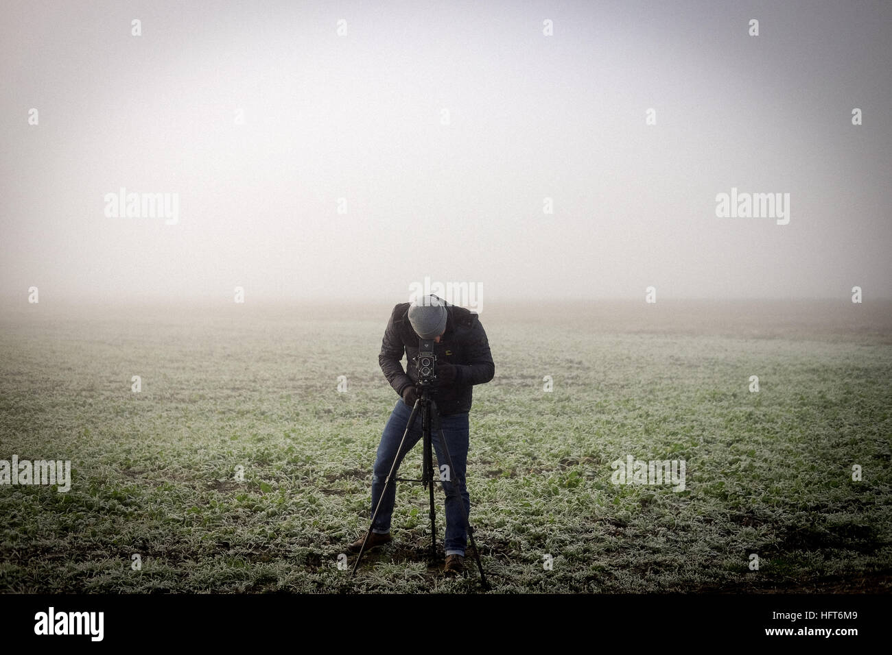 A photographer braves the elements to capture a photograph Stock Photo