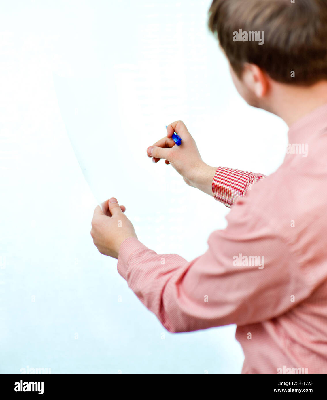 male showing something on transparent paper Stock Photo - Alamy
