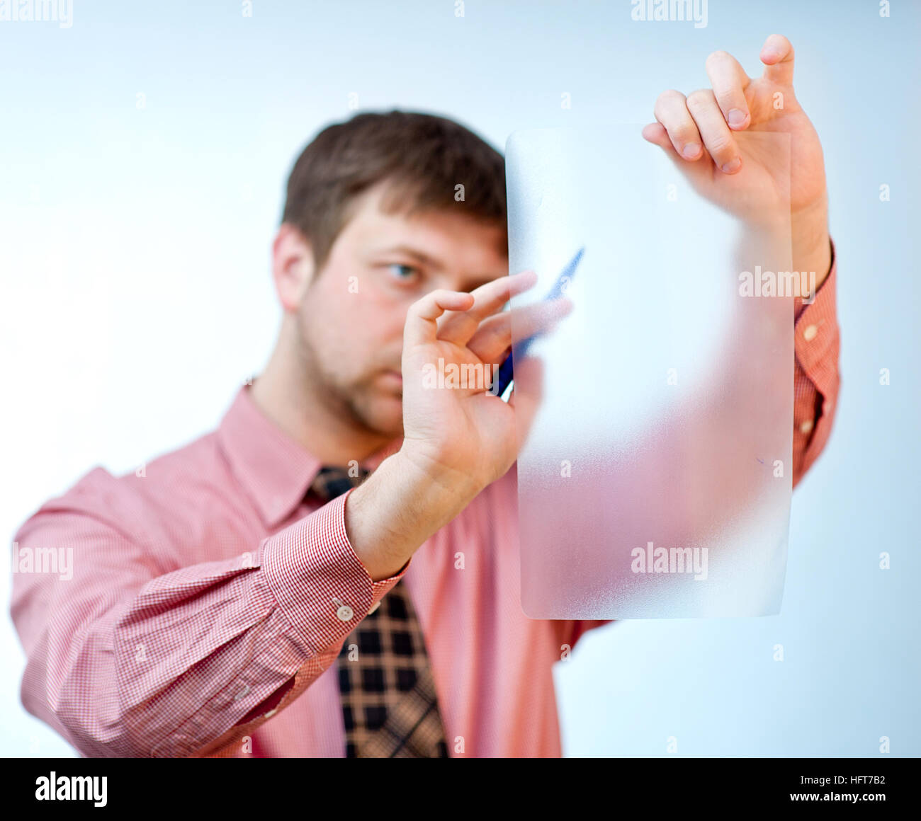 male showing something on transparent paper Stock Photo - Alamy