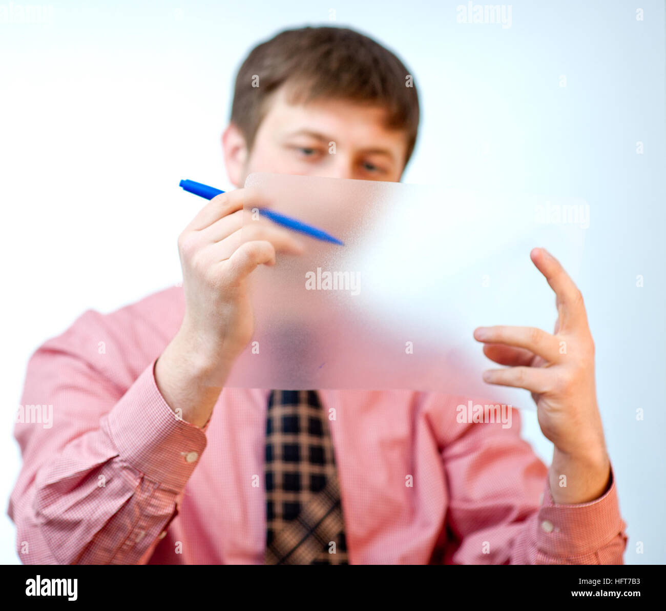 male showing something on transparent paper Stock Photo - Alamy